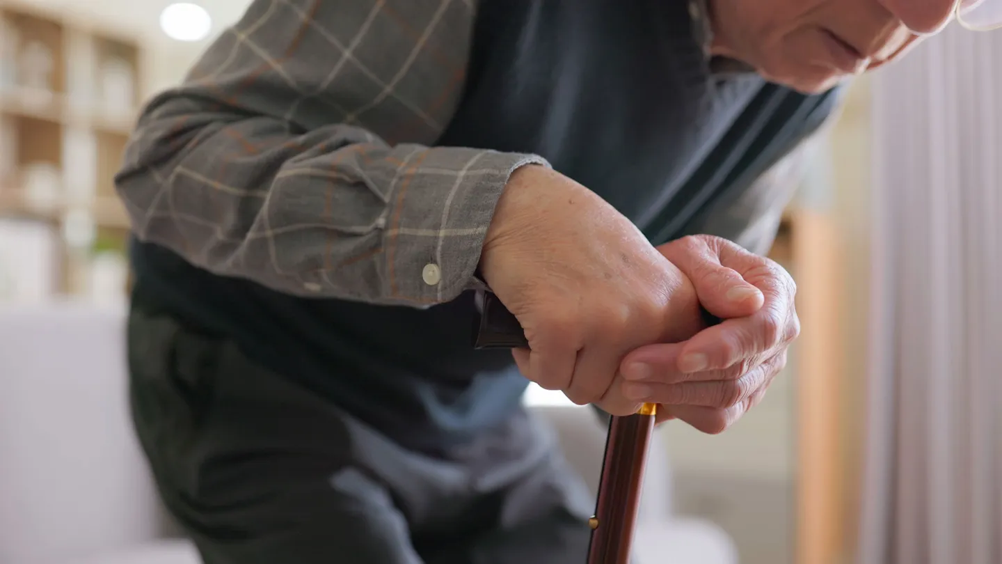 Elderly man having difficulty moving at home