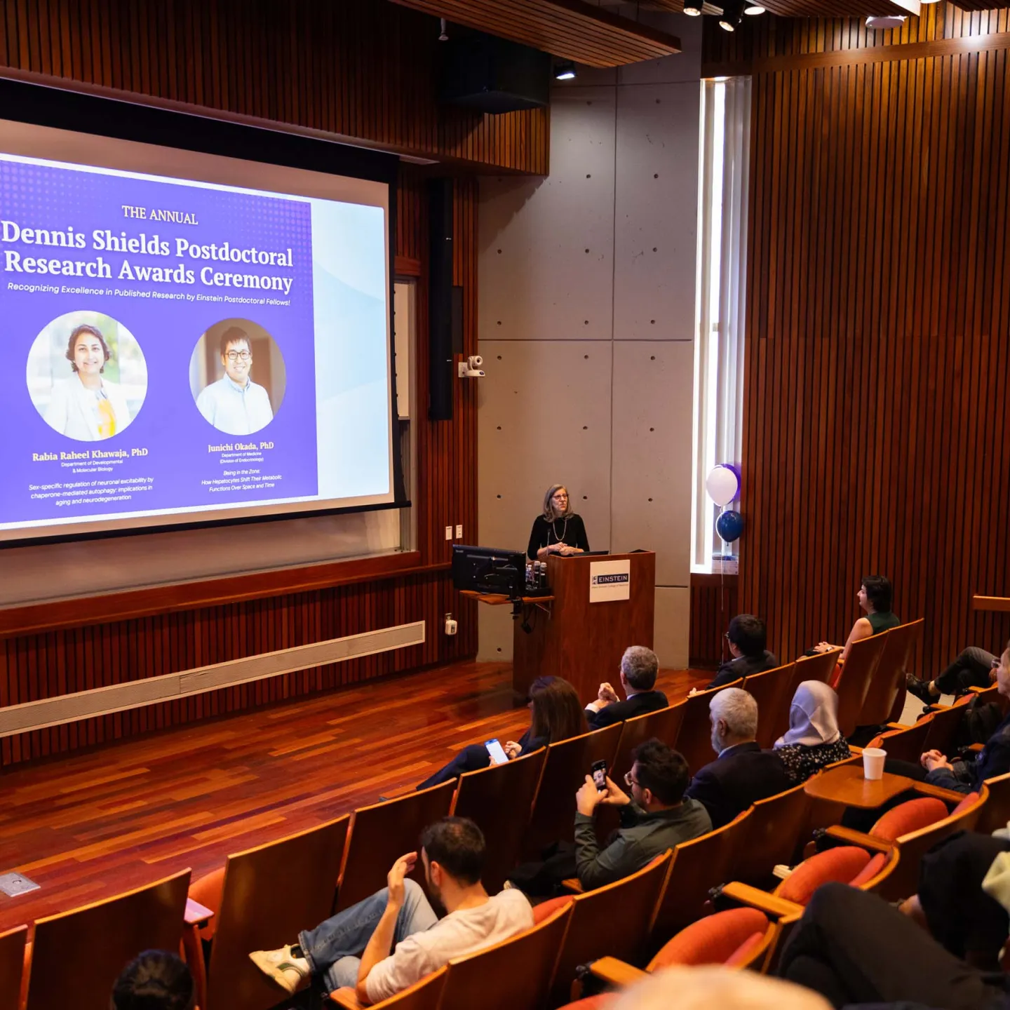 Anne Bresnick at podium speaking in Lefrak Auditorium