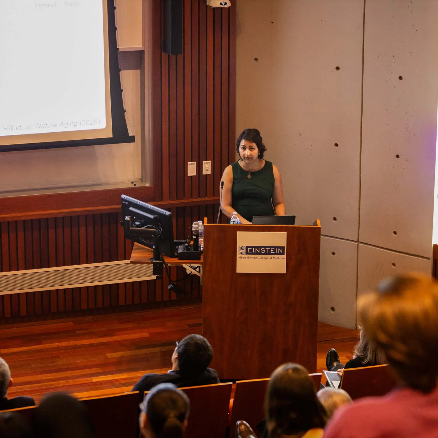 Rabia Khawaja presenting at podium in Lefrak Auditorium