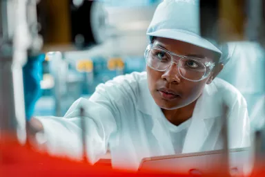 Female factory worker use digital tablet testing program in production line