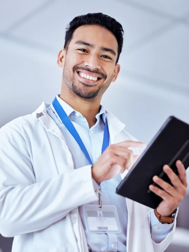 Male doctor smiling in office