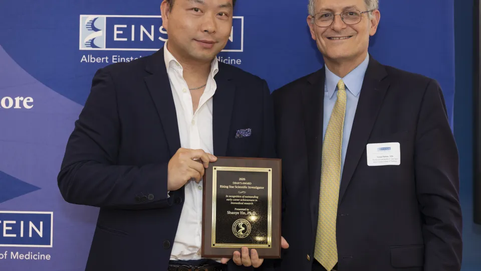 Shanye Yin, PhD, received the inaugural Dean’s Rising Star Scientific Investigator Award from Einstein Dean Yaron Tomer, MD, at the Spring Faculty Celebration held on June 3, 2026. in Lubin Dining Hall. 