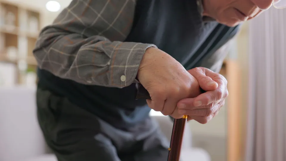 Elderly man having difficulty moving at home
