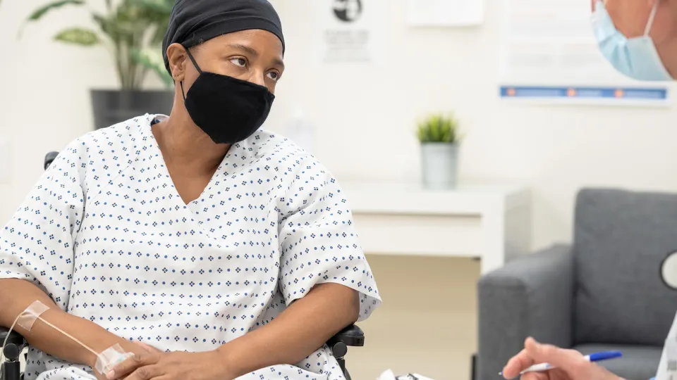 Woman with cancer wearing a face mask