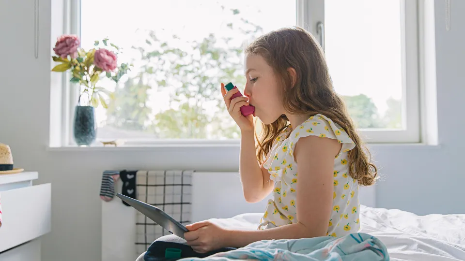 Young Girl with Pink Asthma Inhaler